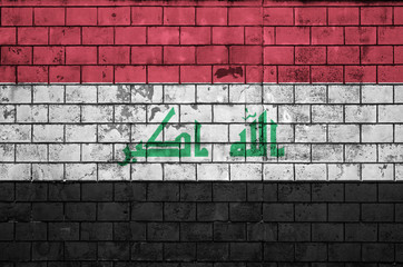 Iraq flag is painted onto an old brick wall