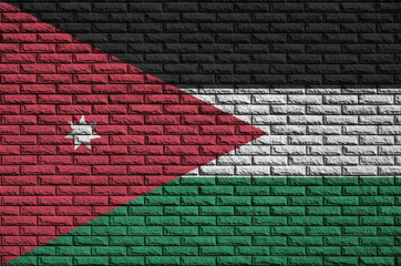 Jordan flag is painted onto an old brick wall