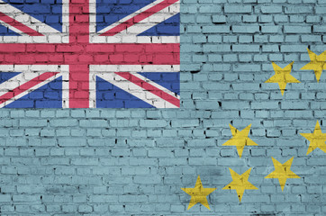Tuvalu flag is painted onto an old brick wall