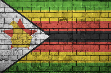 Zimbabwe flag is painted onto an old brick wall