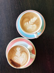 Delicious fresh cappuccino coffee on wooden table