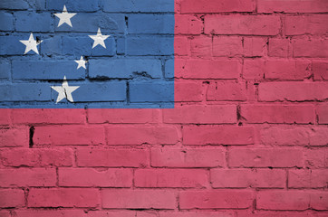 Samoa flag is painted onto an old brick wall