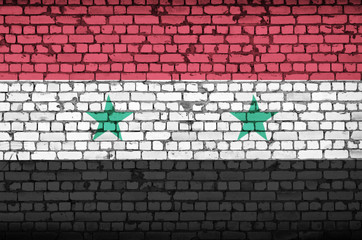Syria flag is painted onto an old brick wall