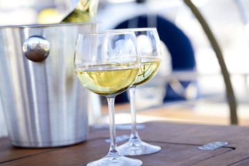 Pair of wineglasses against the yacht