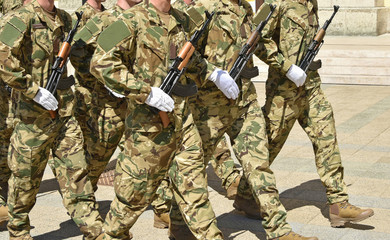 Soldiers are marching at the military parade.