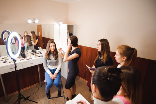makeup teacher with her student girls. Makeup tutorial lesson at beauty school. Makeup master class
