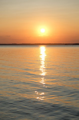 Fototapeta na wymiar Beautiful bright orange summer sunset on the sea. Sun and solar