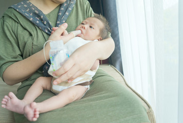 Finger Feeding breast milk to newborn baby boy using small tube
