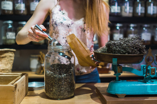 Woman putting spices to bag