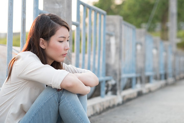 Alone young woman feel sad sitting on the floor. Concept of disappointment,thinking, loneliness,...