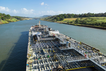 Oil product tanker is proceeding throught the Panama Canal at day time.
