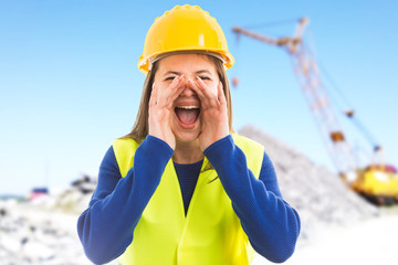 Angry young female engineer shouting.
