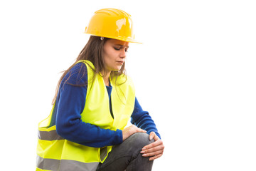 Young woman engineer feeling knee pain .