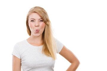 Fototapeta premium Funny blonde woman sitcking tongue out