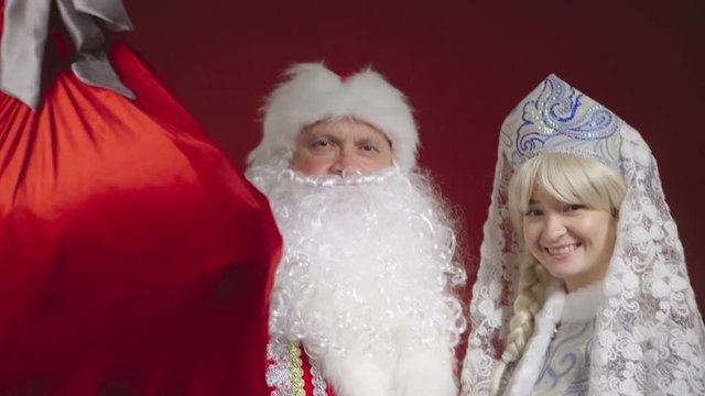 Santa Claus and Snow Maiden congratulates on Christmas