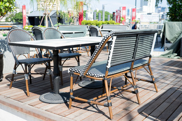 Chairs and table at closed restaurant.