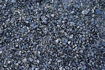 Gravel covered with motor oil.