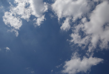 several clouds in sky making blue circle