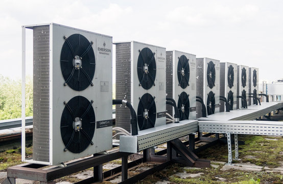 Air conditioner unit fan rotating. Industrial air conditioning sustem on the wall outdoors.	