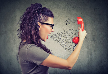 young angry woman yelling at someone on the phone