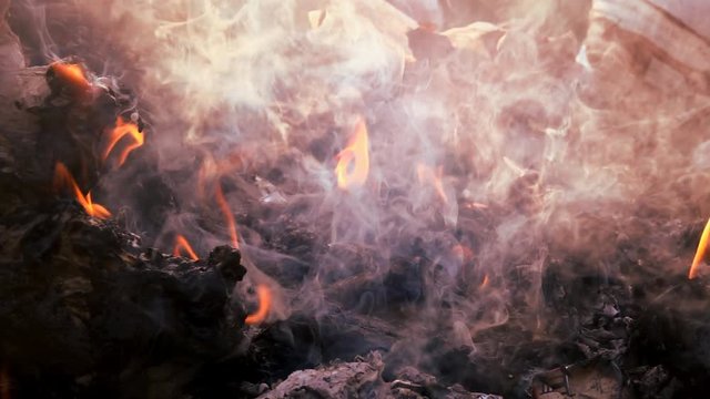 Fire and smoke burning garbage pile to air pollution