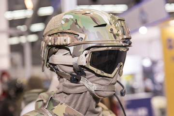 Fototapeta premium Army combat helmet are on, his face closed by using optical sights and night vision