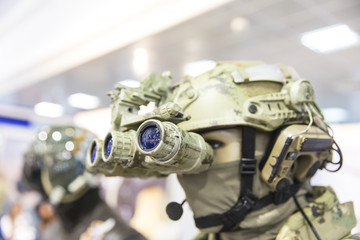 Army combat helmet are on, his face closed by using optical sights and night vision