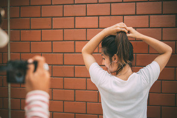 Portrait of chic girl on brick wall