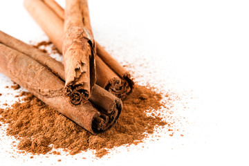 Cinnamon sticks and powder isolated on white background. Copyspace
