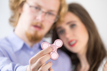 Couple playing with fidget spinner