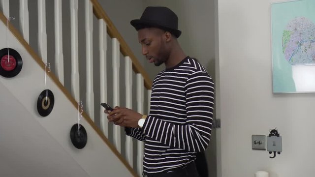 Young Couple Wear The Same Outfit And Begin Arguing At Home. Handheld Shot Of White Girlfriend Descending Stairs To Join Black Boyfriend And Beginning To Argue - Wearing Matching Outfits