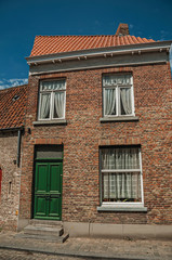 Brick facade of house in typical style of the Flanders’s region in street of Bruges. With many canals and old buildings, this graceful town is a World Heritage Site of Unesco. Northwestern Belgium.