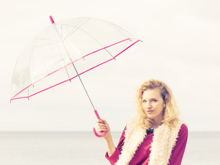 Woman having fun outdoor with umbrella