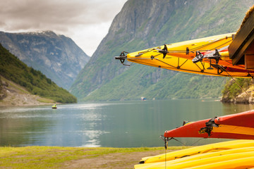 Many canoes on norwegian fjord shore