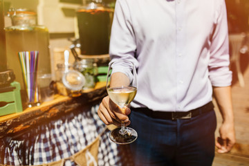 Man with a glass of white wine in hand