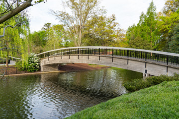 Fototapeta na wymiar Bridge Over Lake in Pullen Park