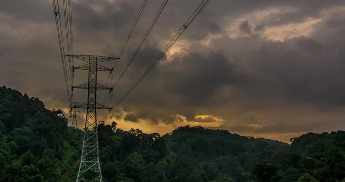 Time lapse of high voltage power line through a valley inside deep tropical jungle