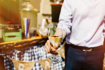 Man with a glass of white wine in hand