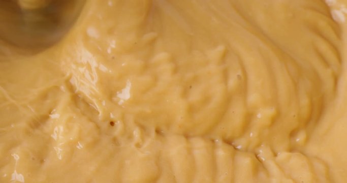 Very close video of mixing homemade butterscotch pudding with beaters.