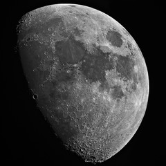 Closeup of growing Moon in the dark background, with craters details, taken with large newtonian...