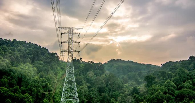 Time lapse of high voltage power line through a valley inside deep tropical jungle