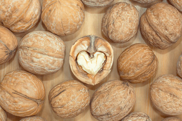 Walnut heart shaped and whole nuts. concept of love for nuts, health benefits, healthy food