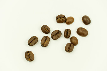 close up of medium or dark roasted coffee beans isolated on white background, can be used as a background or graphic object in your ads.