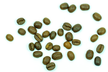 close up of medium or dark roasted coffee beans isolated on white background, can be used as a background or graphic object in your ads.