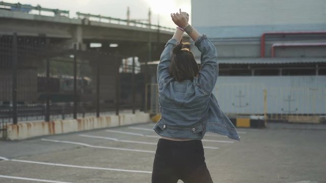 Attractive beautiful young woman riding roller skating and dancing in the streets. Urban background, slow motion 120fps