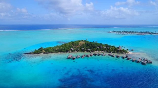 Aerial view of tropical paradise of Bora Bora island, turquoise crystal clear water of scenic lagoon, typical over water bungalows, Motu Piti 'U'u Uta (Sofitel) - South Pacific Ocean, French Polynesia