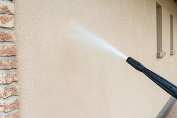 power washing the wall - cleaning the facade of the house - obrazy, fototapety, plakaty