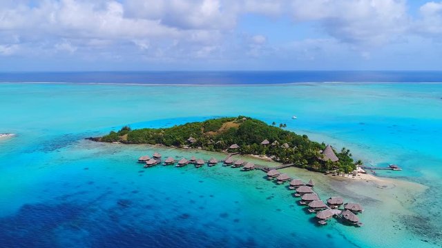 Aerial view of tropical paradise of Bora Bora island, turquoise crystal clear water of scenic lagoon, typical over water bungalows, Motu Piti 'U'u Uta (Sofitel) - South Pacific Ocean, French Polynesia