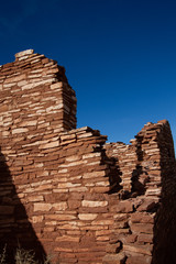 Fototapeta premium The ruins of ancient Anasazi Lomaki Pueblo are protected inside Wupatki National Monument near Flagstaff, Arizona