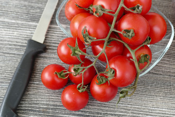 Vine tomatoes and knife on black back ground,

